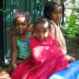 Garden members’ children dry off after swimming in an inflatable pool.